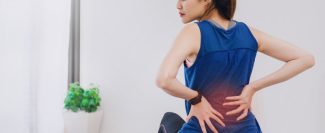 asian-beautiful-woman-sitting-fitball-feeling-backache-while-play-yoga-exercise-home-min