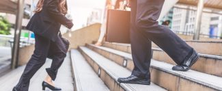 businessman-business-woman-up-stairs-rush-hour-work-min
