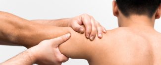 male-patient-getting-shoulder-massage-from-physiotherapist-min
