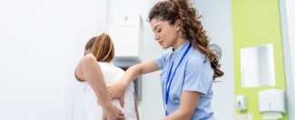 physiotherapist-doing-healing-treatment-womans-back-back-pain-patient-treatment-medical-doctor-massage-therapistoffice-syndrome-min
